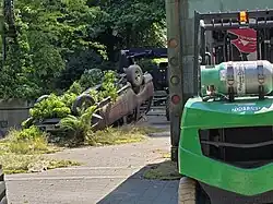 Film set of a flipped car with foliage