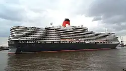 The ship turns towards the dry dock at high tide without tug assistance