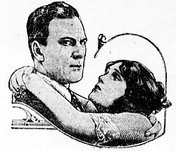 Black and white newspaper photograph showing a man and woman in 1920s attire