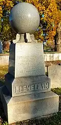 Tombstone topped with orb symbolizing a celestial body and the reward of resurrection, churchyard of St. Peter's Church in the Great Valley, Malvern, Chester County, Pennsylvania