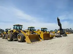 Large wheel loader trucks parked