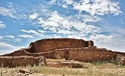 A color picture of a tall masonry tower built from tan sandstone
