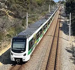 Electric passenger train viewed from a bridge