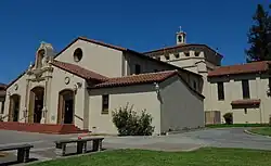 A church with white walls and a brown roof