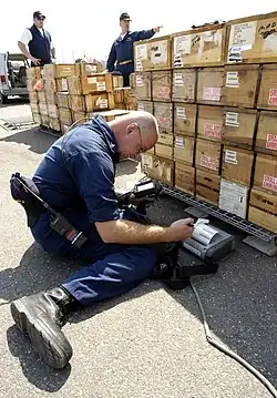 Checking bar codes on wooden ammunition boxes