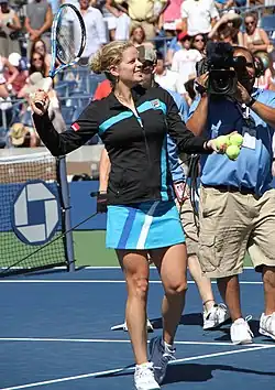 Clijsters preparing to hit souvenir tennis balls into the crowd after her first round match win