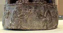 Tribute bearers (base of the statue)