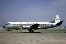 An older white-and-blue plane on the tarmac