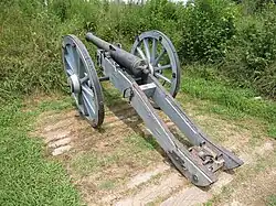 Photo shows an old French cannon.