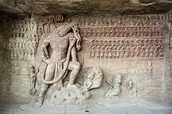 Vishnu in the form of Varaha, Udayagiri caves, circa 400 CE.[62] In front, probable relief of Chandragupta II (380–415 CE) kneeling, paying homage to Varaha.[63]