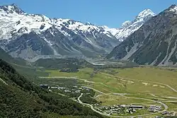 Mount Cook Village down below in Hooker Valley, The Hermitage on the left, lodge and motel complex on the bottom right