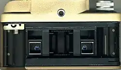 View of the back of the camera with the film chamber visible. With the selector in the A position, the lenses are pointing to the bottom half of the film.