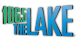 Two lines of text on the left side, slanted in opposite directions. The top line reads "106.5" in green text, the bottom line reads "THE" in blue text. The right side reads "LAKE" in large blue text.