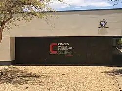 The name of the building written on the wall with the school logo above it.