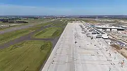 Terminal, runway and surrounding apron in January 2025