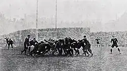A mass of players compete for the ball in a scrum.
