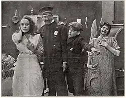 At left in Who Stole the Doggies? (1915)