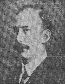 Black and white photo of a middle-aged man wearing a suit and tie