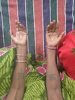 Woman displaying traditional tattoos on her hands. Resident of Naiyyasi village, Bihar, India.