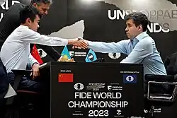 Ding and Nepomniachtchi shaking hands.