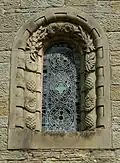 A window of St Mary's Church, surrounded with reliefs of shells and pine cones