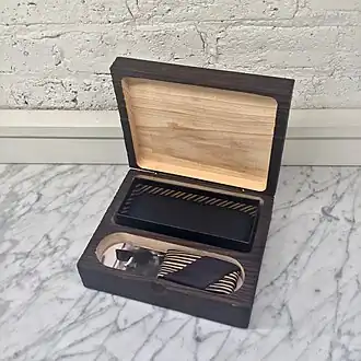 Small wooden box with yakisugi treatment showing deep black charred surface used for sunglasses storage