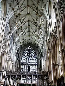 This interior view at York shows the Gothic style becoming less about projecting forms and more about surface treatment. The walls, vault and east window are all covered with a decorative net-like tracery. The pattern of the vault ribs resembles interconnecting stars.