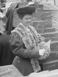 Frances Cleveland stands holding a trowel